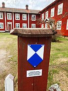 Ett blå-vitt emblem på en grindstolpe